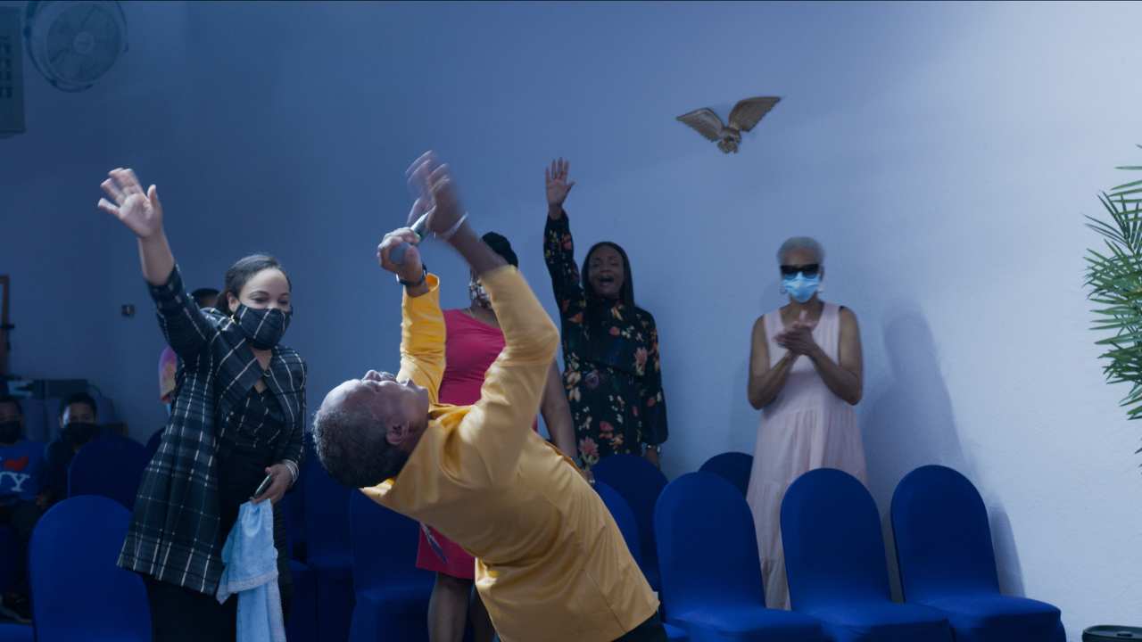 a group of people cheering in blue chairs